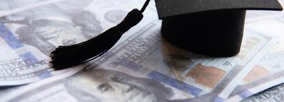 Photo of a graduation cap and money