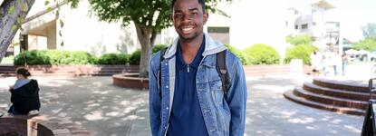 Photo of a student posing for a photo in the Delta College quad