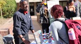 An HBCU representative talking with a Delta College student