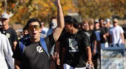 A Delta College athlete puts his arm in the air in celebration of Delta's new fields
