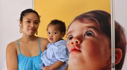 A student and her child pose for a photo outside one of the new lactation pods.