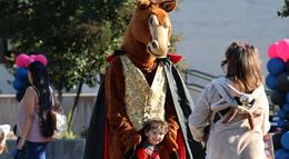Photo of Fierce the Mustang interacting with a child at Fierce's Fall Fest