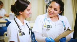 Two nursing students studying a patient's chart