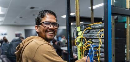 Student smiling while working on CISCO Networking project
