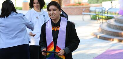 Student graduate with certificate at Lavender Graduation