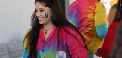 A Chemistry Club student smiles while teaching children about science