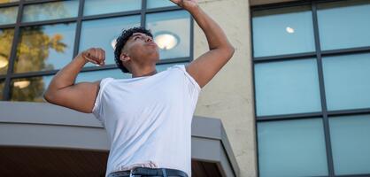 A Delta College student poses for a photo in front of the library