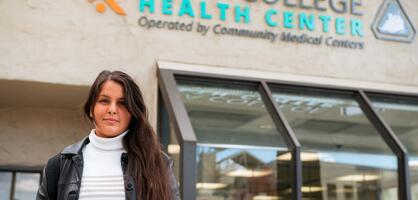 A student stands in front of the Delta College Health Center