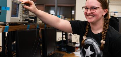 A student poses in a classroom