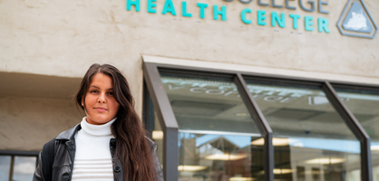 Student in front of Health Center