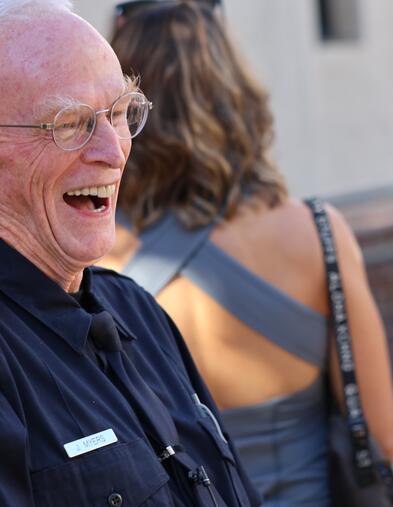POST Academy student smiling and laughing with a group of people in the background