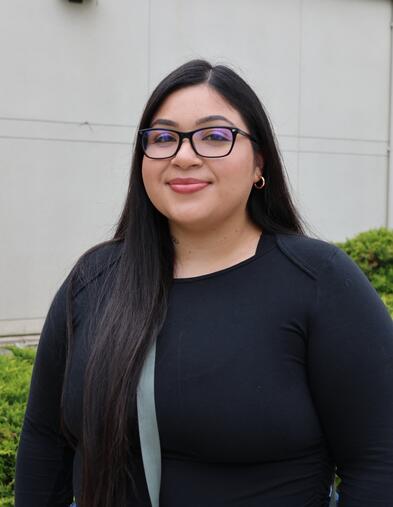Portrait of student smiling in front of Electron Microscopy building