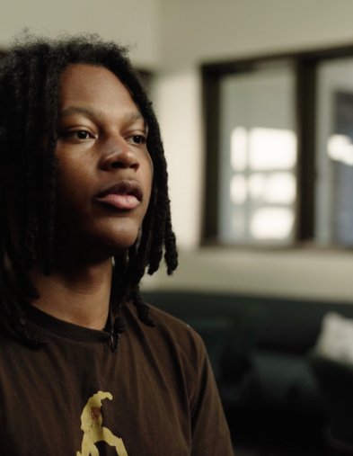 Portrait of student sitting in front of windows