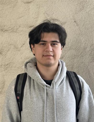 Student smiling in a headshot against a neutral background.